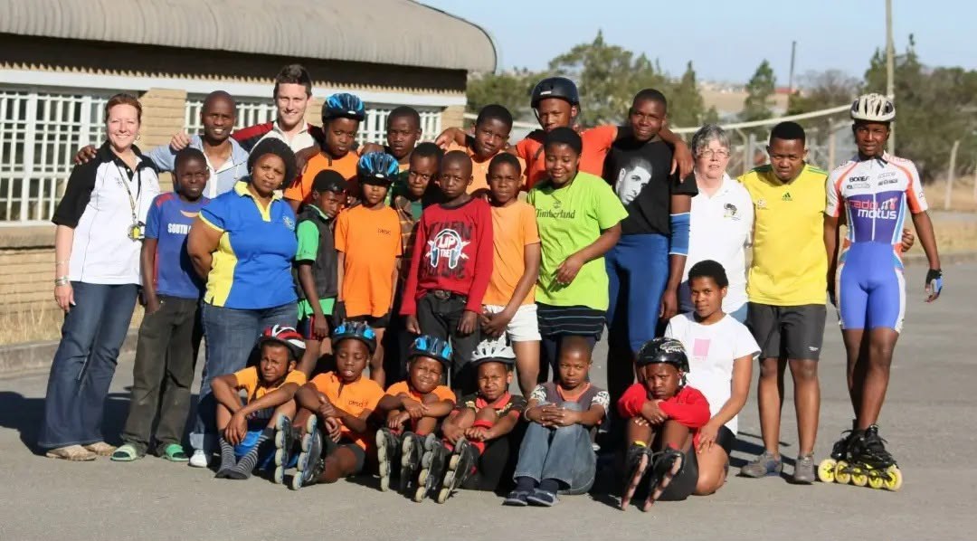 Young skaters, families and supporters gathered for a group photo