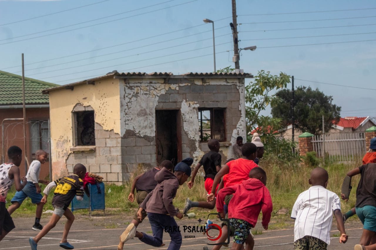 Young runners sprinting a training race across an outdoor court