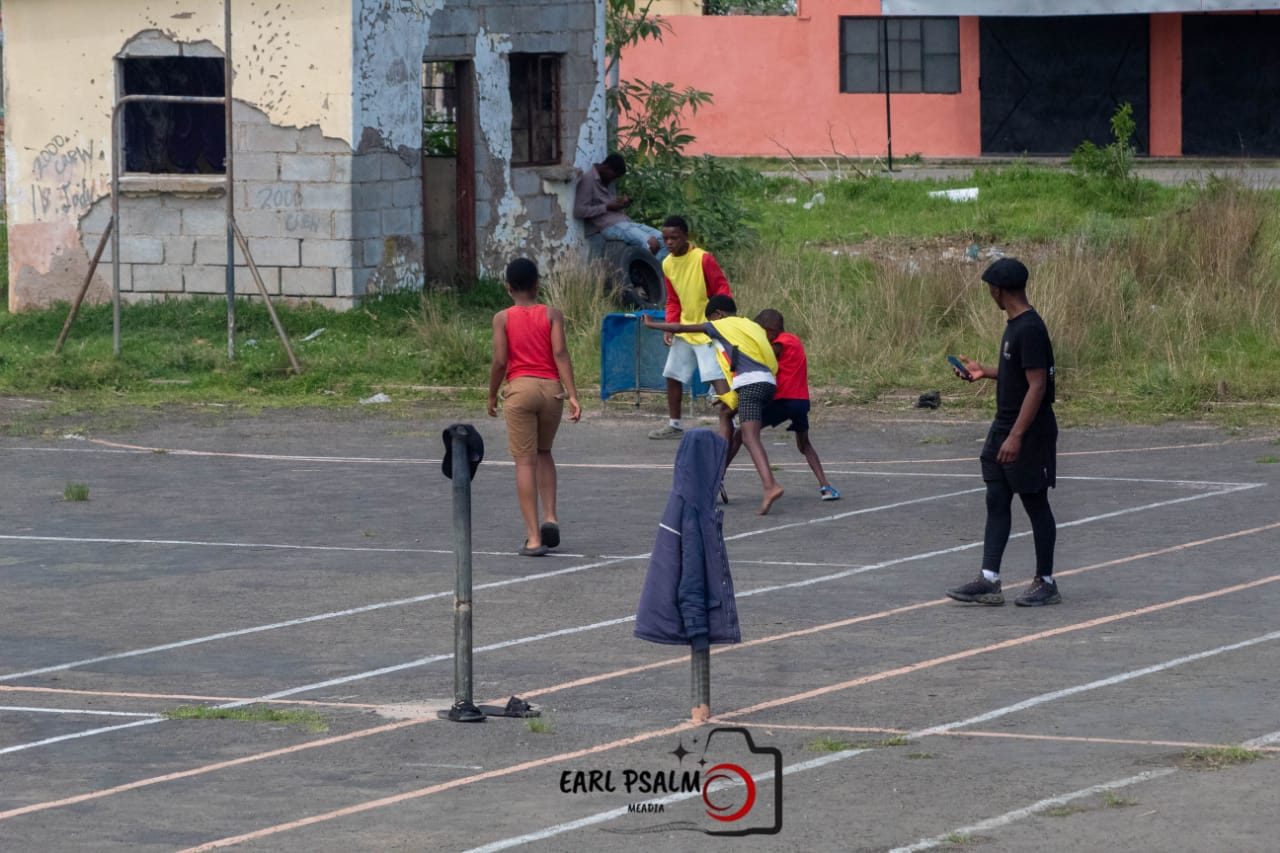 Children playing a small-sided ball game on an outdoor court in Dimbaza